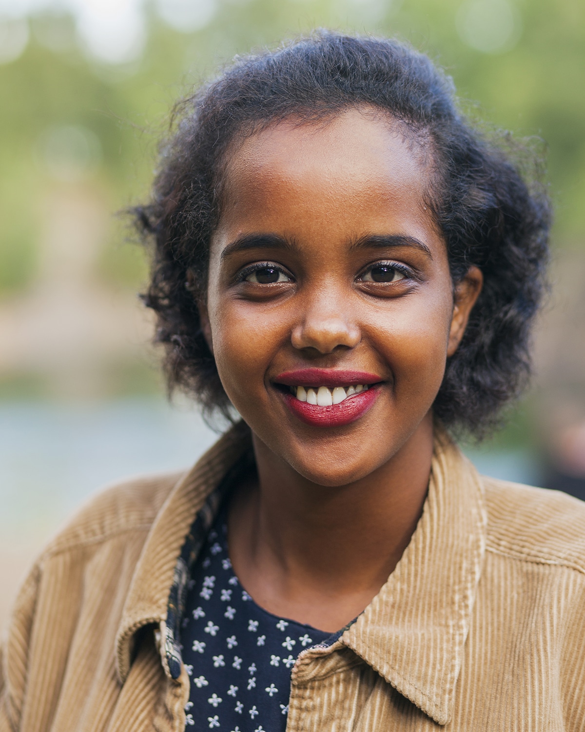 Portrait of happy young woman smiling outdoors