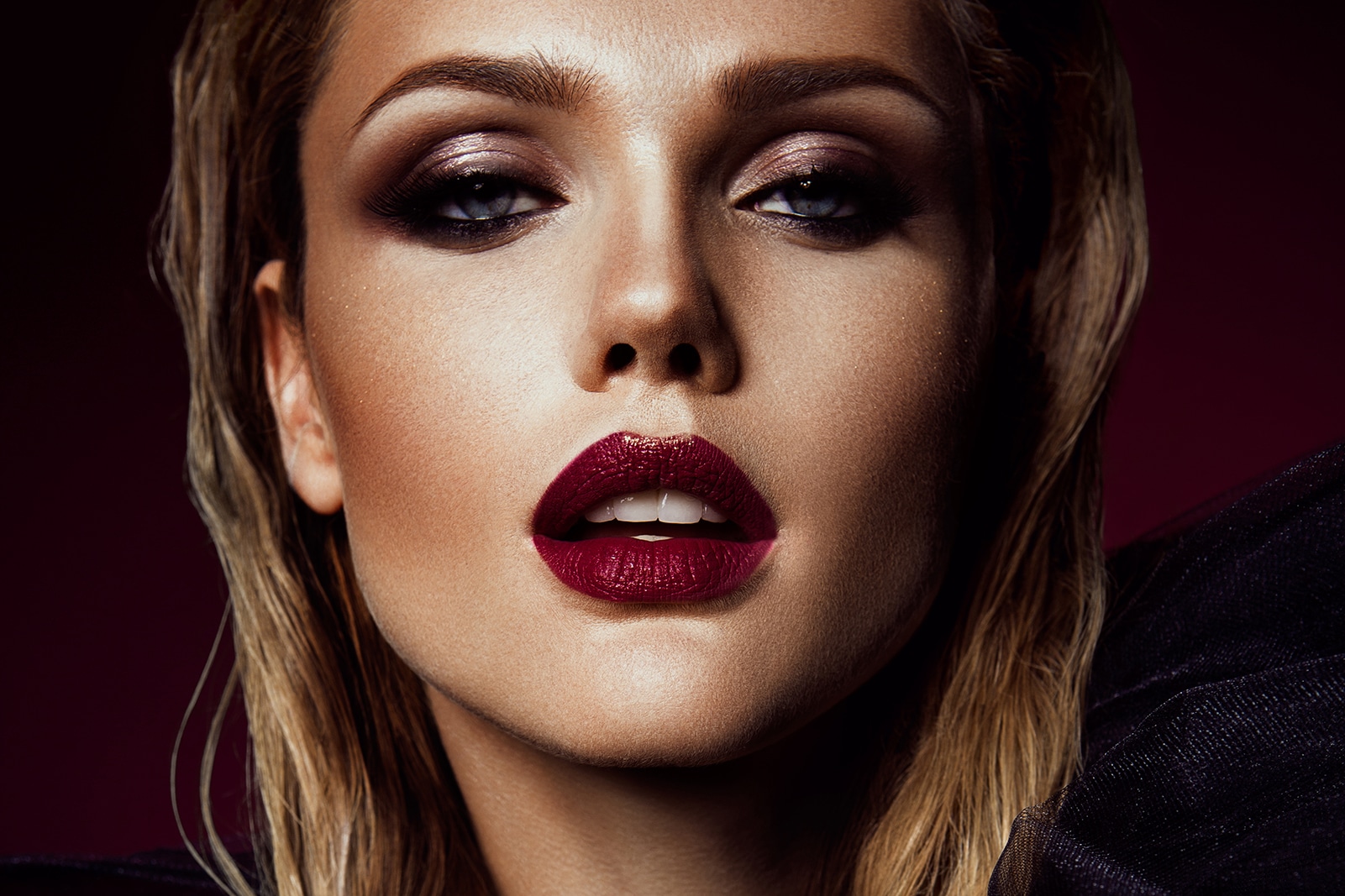 Close-up portrait of beautiful woman with bright make-up and red lips